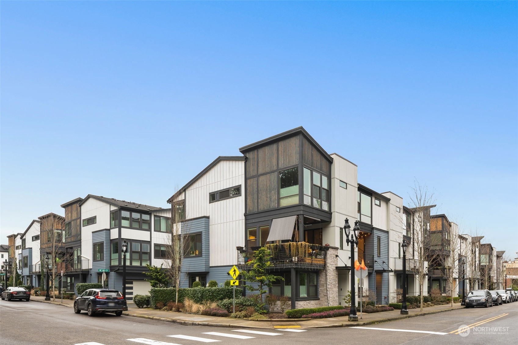 9604 Main Street, Unit B Bothell, WA 98011 - Photo 2 of 34 a front view of a building with lot of cars and trees