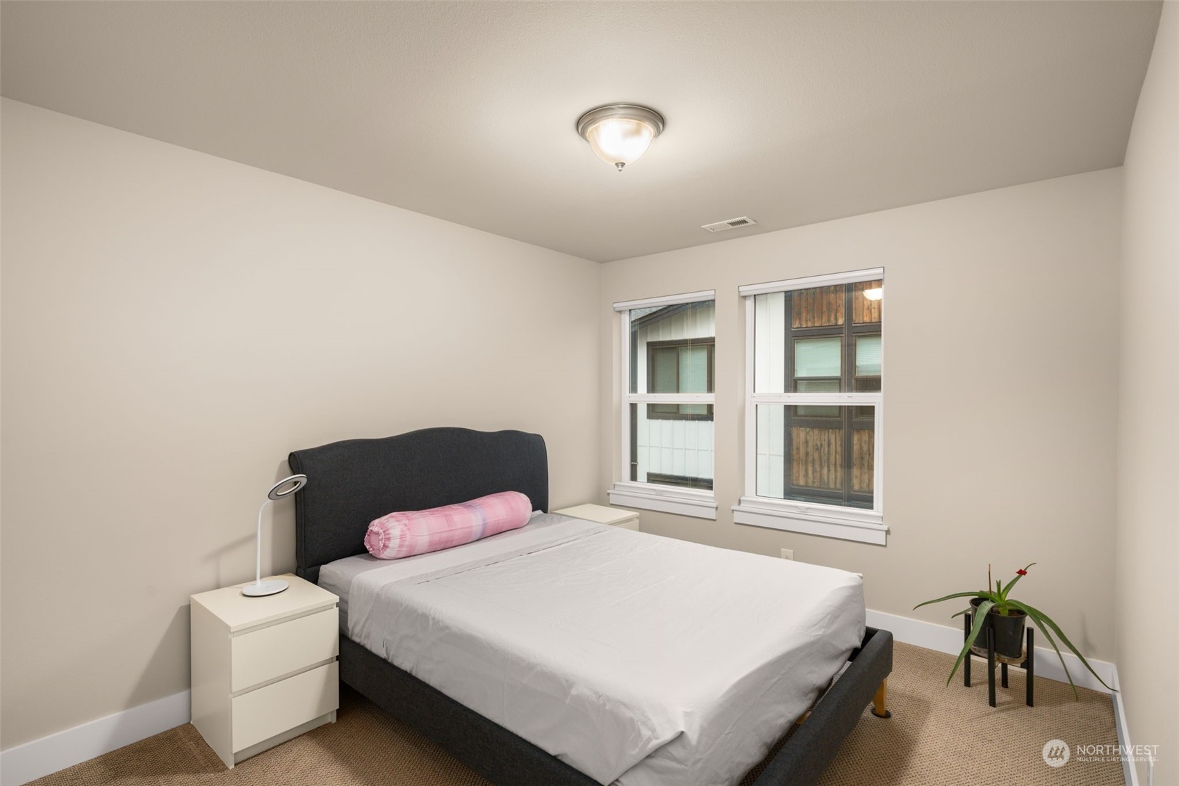 9604 Main Street, Unit B Bothell, WA 98011 - Photo 21 of 34 a bedroom with a bed next to a window with yard