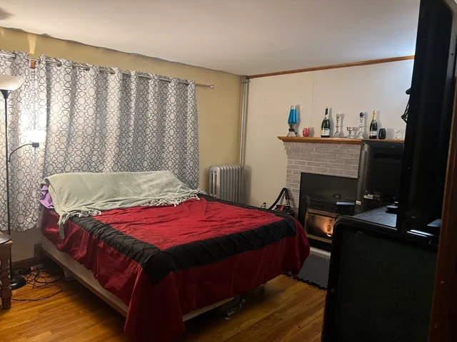 a bedroom with a bed and a flat tv screen