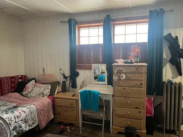 a bedroom with a bed and a television