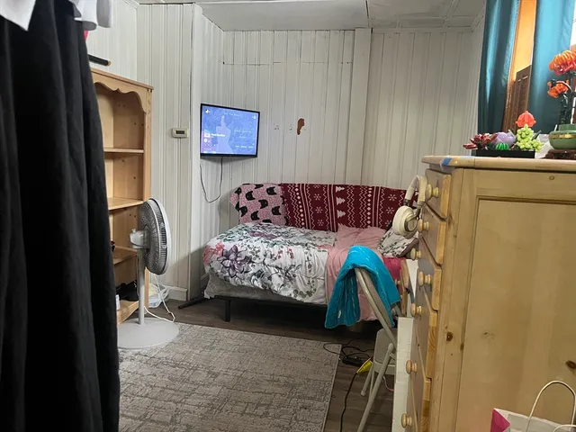 a bedroom with a bed and a couch