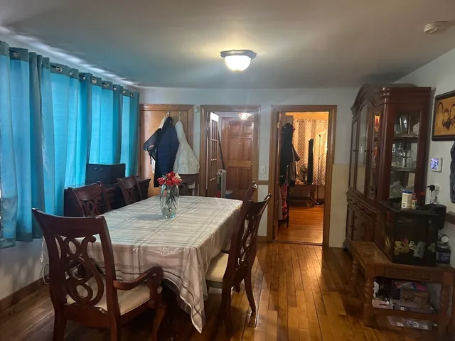 a view of a dining room with furniture and chandelier