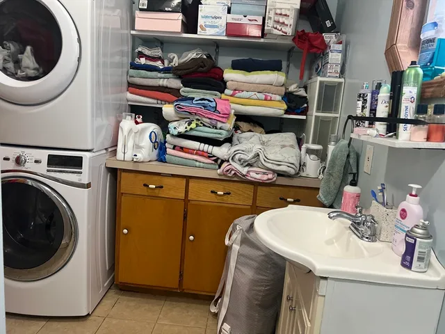 a utility room with sink dryer and washer