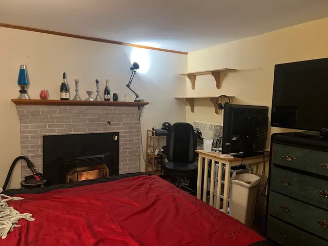 a view of a livingroom with furniture and a fireplace