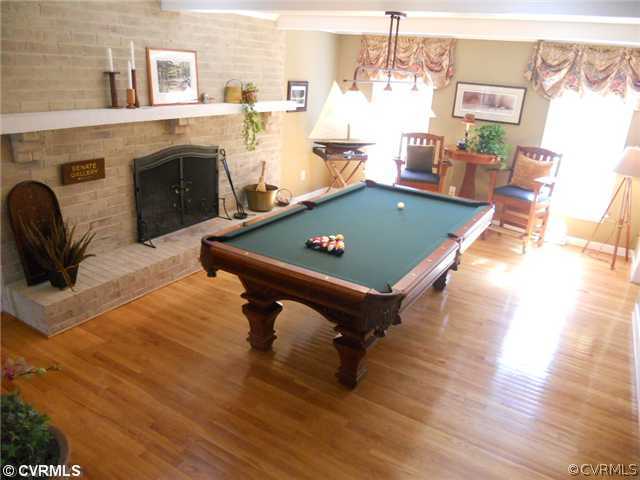 2551 Kentford Road Midlothian, VA 23113 - Photo 8 of 12 a living room with furniture pool table and a fireplace