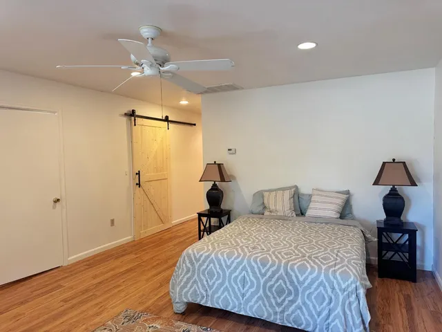 a bathroom with a tub a toilet and a shower