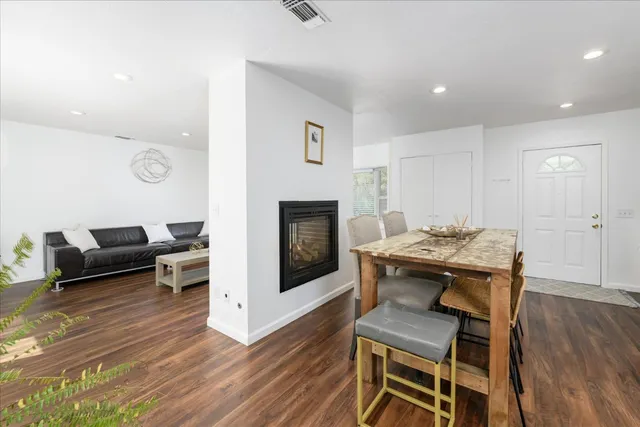 a kitchen with stainless steel appliances cabinets and wooden floor