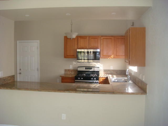 67235 Verona Road Cathedral City, CA 92234 - Photo 5 of 14 a kitchen with a refrigerator and a stove top oven