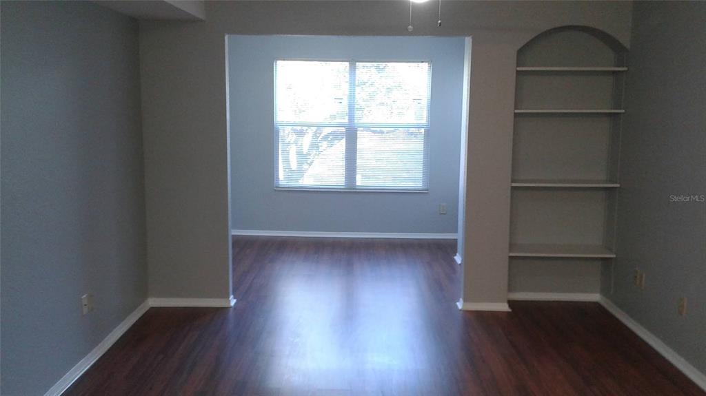 829 Camargo Way, Unit 203 Altamonte Springs, FL 32714 - Photo 17 of 26 an empty room with wooden floor and window