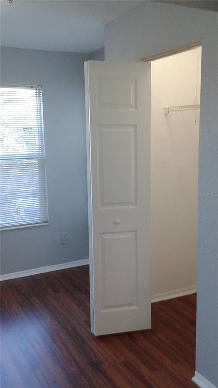 829 Camargo Way, Unit 203 Altamonte Springs, FL 32714 - Photo 19 of 26 an empty room with wooden floor and closet
