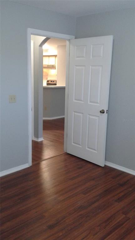 829 Camargo Way, Unit 203 Altamonte Springs, FL 32714 - Photo 22 of 26 an empty room with wooden floor and windows