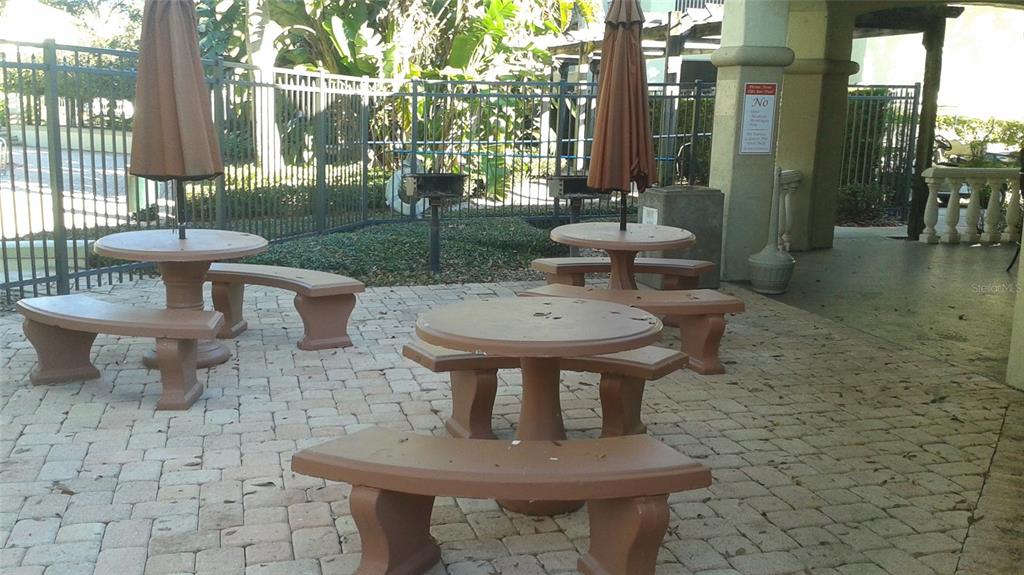829 Camargo Way, Unit 203 Altamonte Springs, FL 32714 - Photo 8 of 26 a view of a patio with table and chairs potted plants and large tree