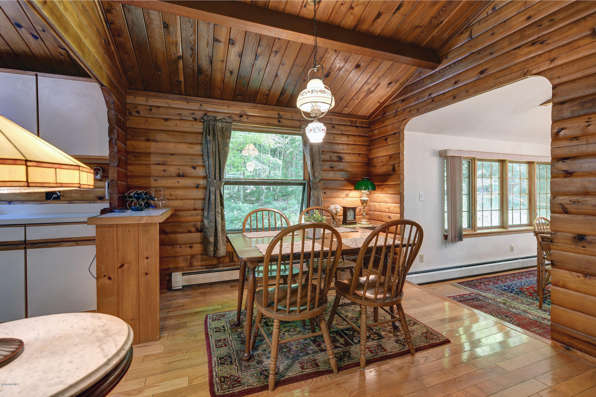 2399 Swamp Road Richmond, MA 01254 - Photo 15 of 36 a dining room with furniture a rug and wooden floor