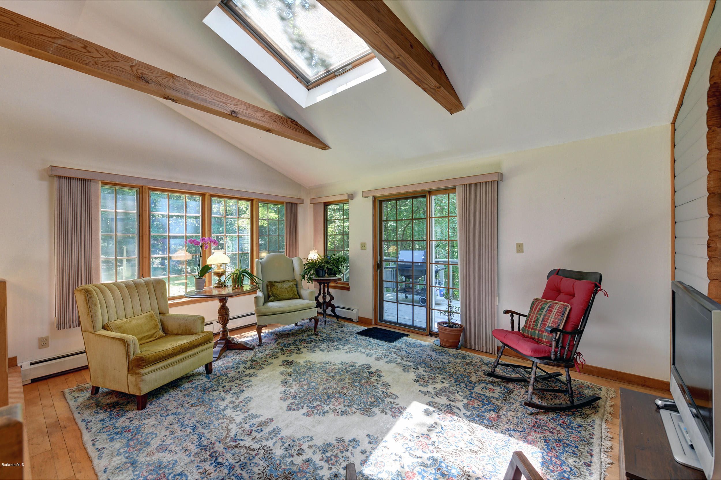 2399 Swamp Road Richmond, MA 01254 - Photo 16 of 36 a living room with furniture and a floor to ceiling window