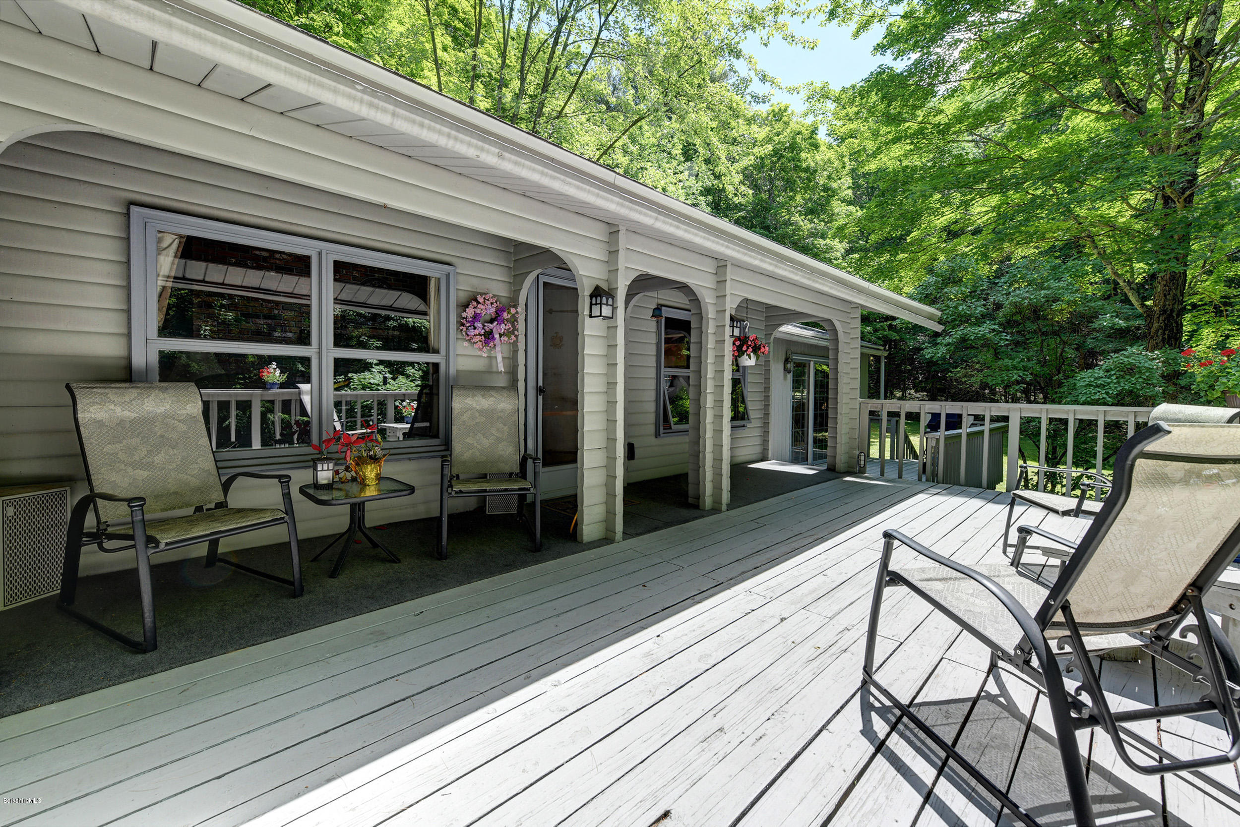 2399 Swamp Road Richmond, MA 01254 - Photo 4 of 36 a view of a patio with two chairs and table on the wooden floor