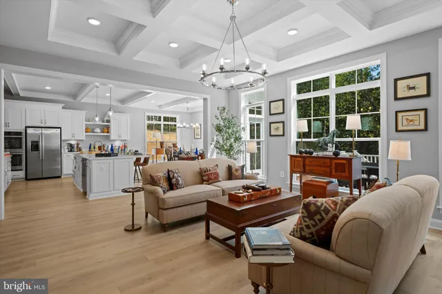 a living room with furniture a table and a window