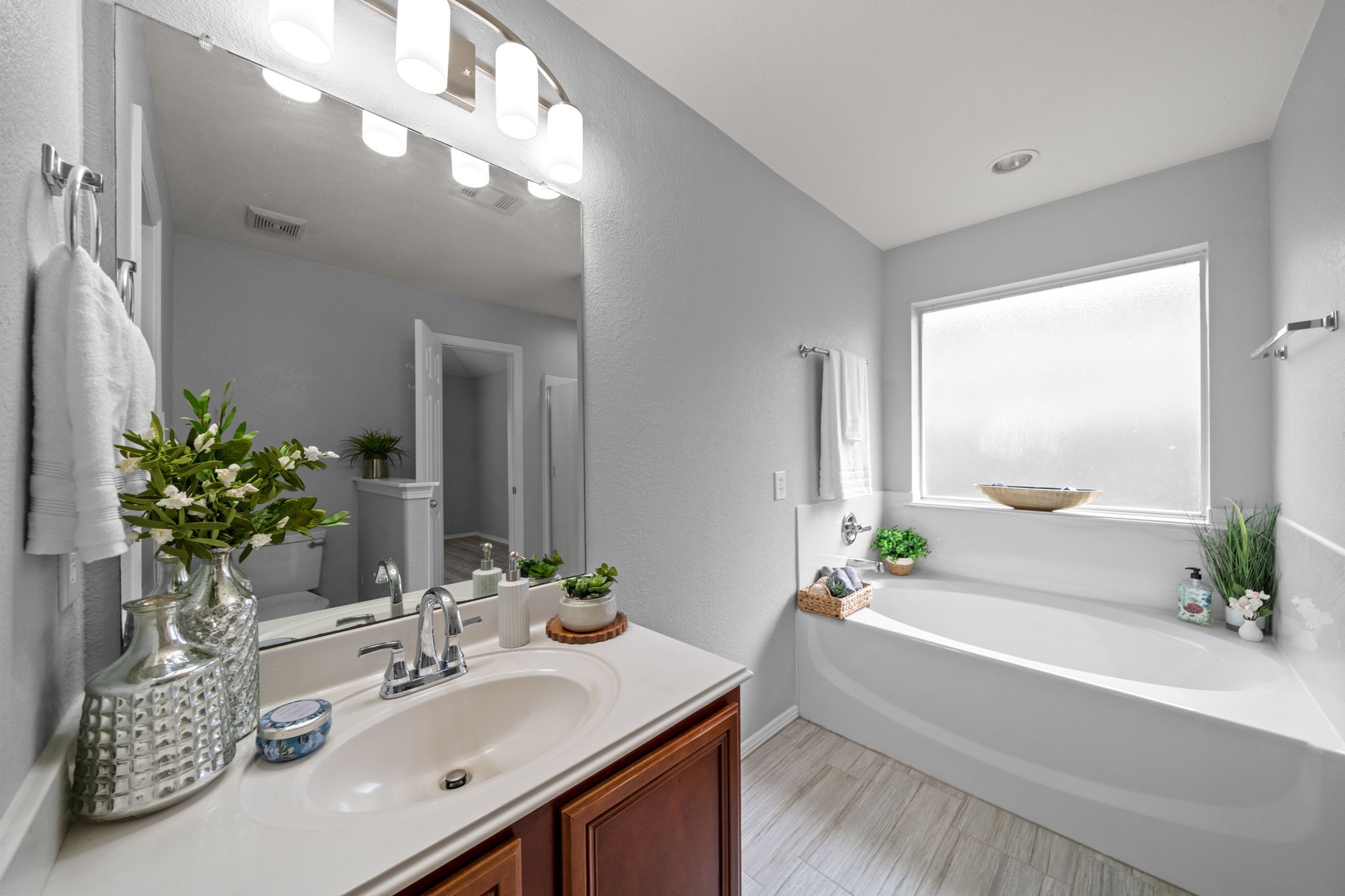 694 St Croix Alvin, TX 77511 - Photo 13 of 30 a bathroom with a granite countertop sink a large mirror and a bathtub