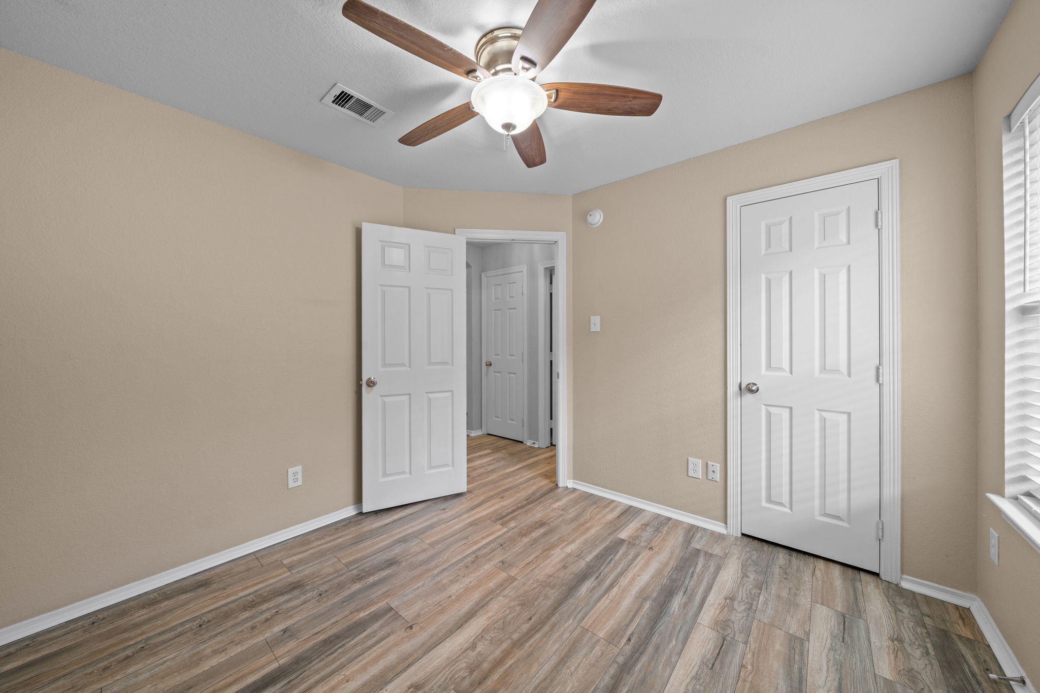 694 St Croix Alvin, TX 77511 - Photo 20 of 30 an empty room with wooden floor chandelier fan and closet area