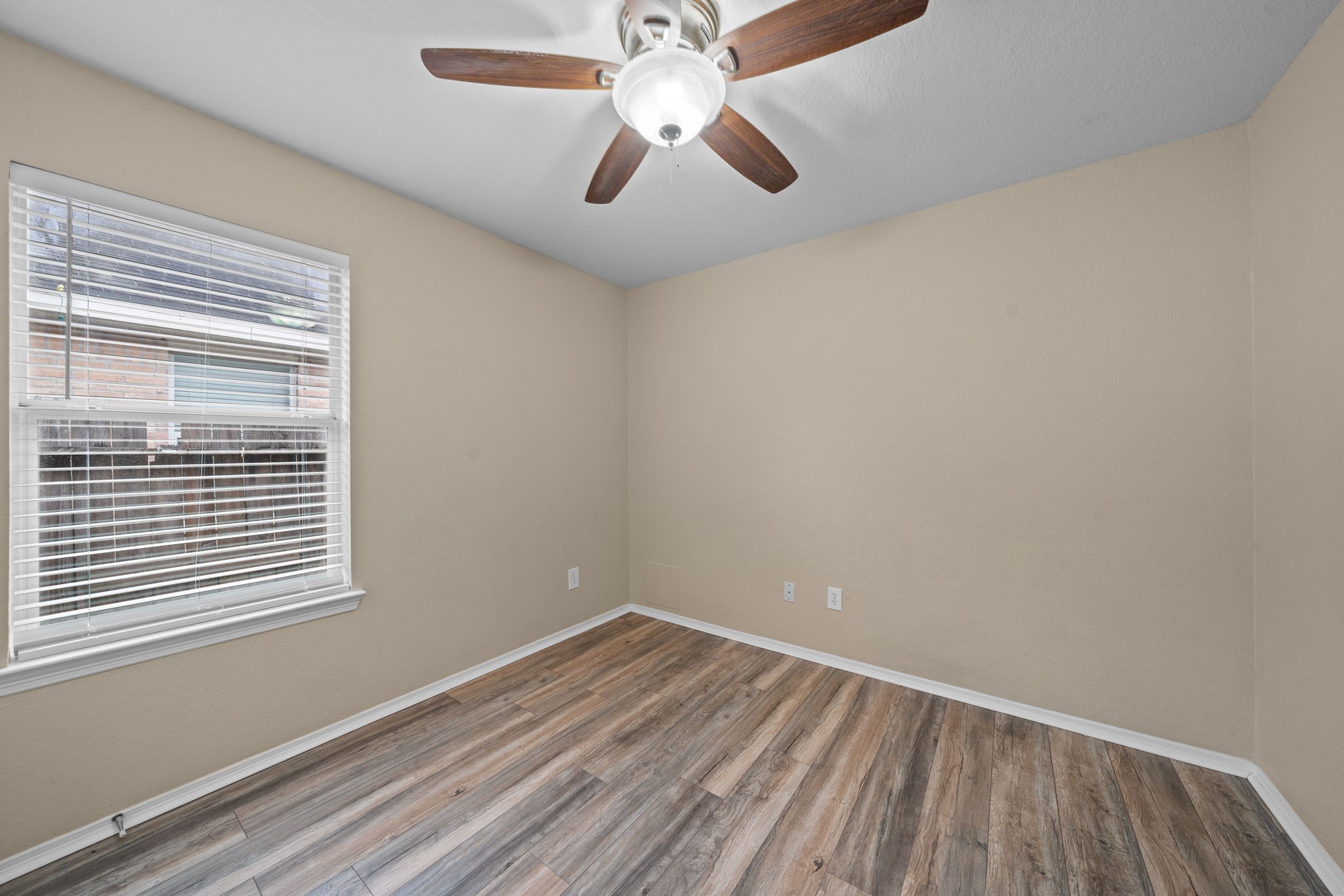 694 St Croix Alvin, TX 77511 - Photo 23 of 30 a view of empty room with wooden floor and fan