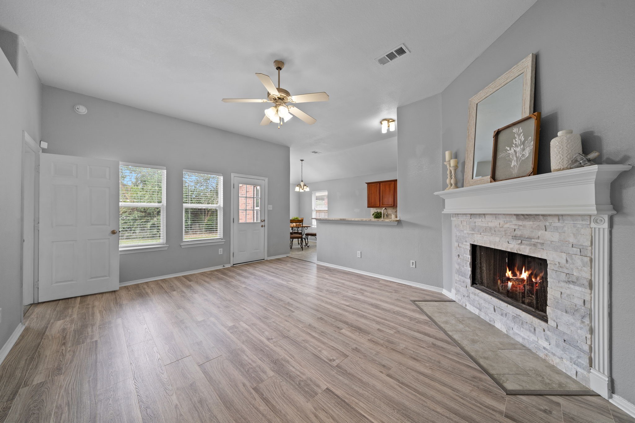 694 St Croix Alvin, TX 77511 - Photo 3 of 30 a view of empty room with wooden floor fireplace and windows