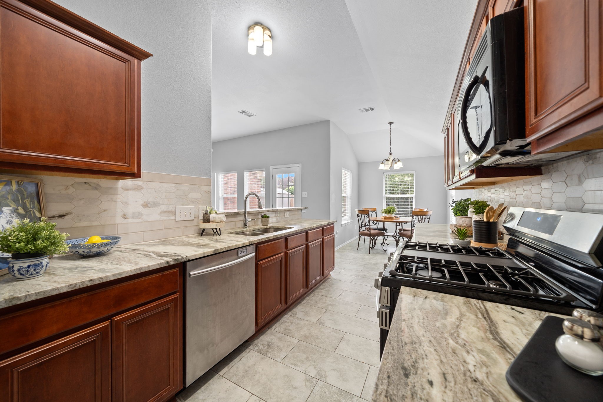 694 St Croix Alvin, TX 77511 - Photo 6 of 30 a kitchen with a sink stove and cabinets