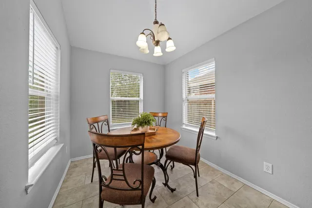 a dining room with furniture and window