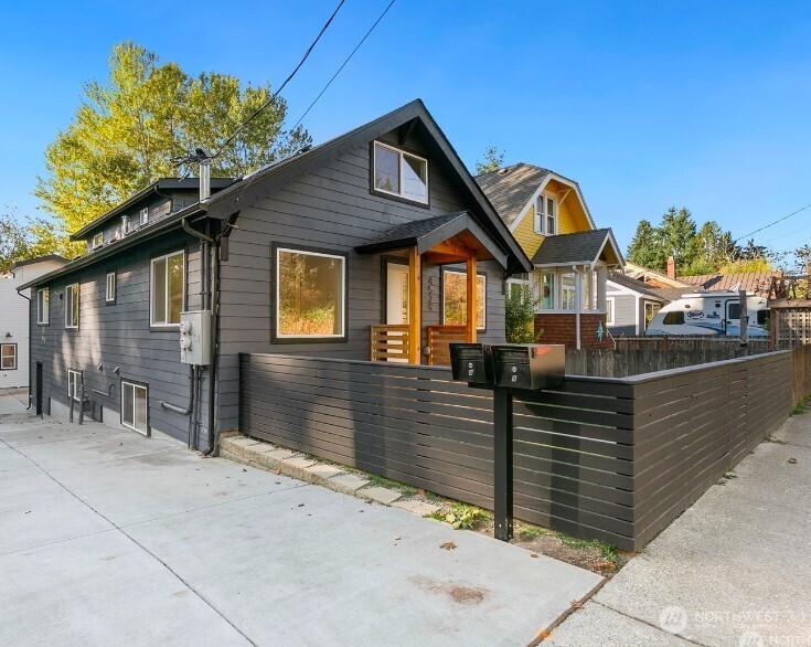 4529 26th Avenue Southwest Seattle, WA 98106 - Photo 1 of 1 a front view of a house with iron fence