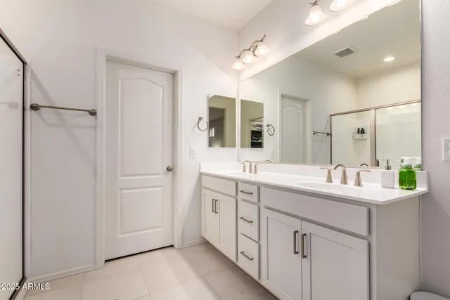 a bathroom with a double vanity sink and mirror