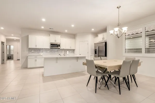 a kitchen with stainless steel appliances kitchen island granite countertop a sink and cabinets