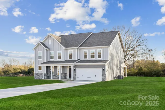 a front view of a house with a yard table and chairs