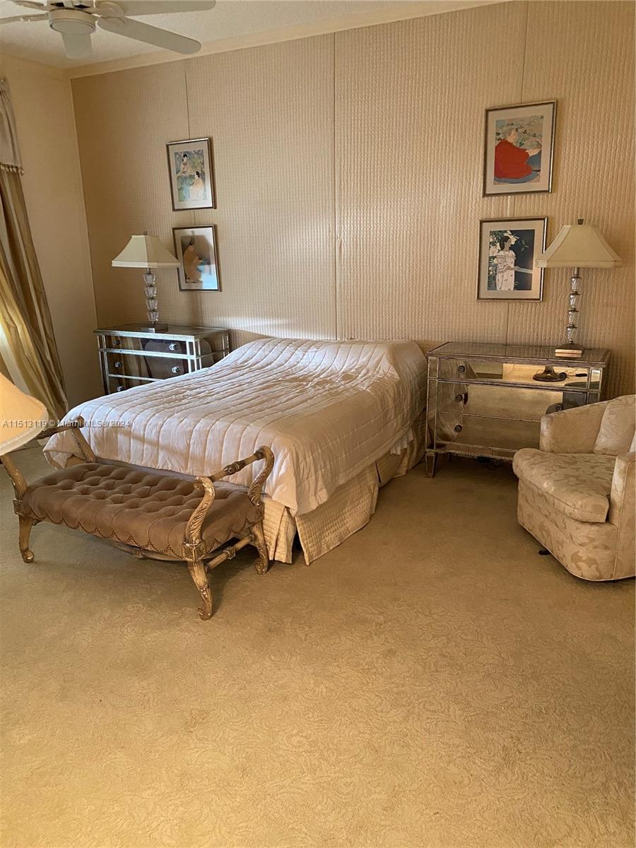 Boca West Boca Raton, FL 33434 - Photo 18 of 28 a bedroom with a bed and a cabinets