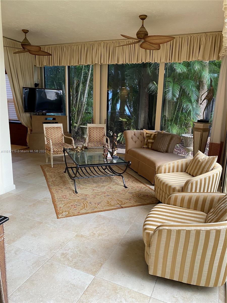 Boca West Boca Raton, FL 33434 - Photo 19 of 28 a living room with furniture and a flat screen tv