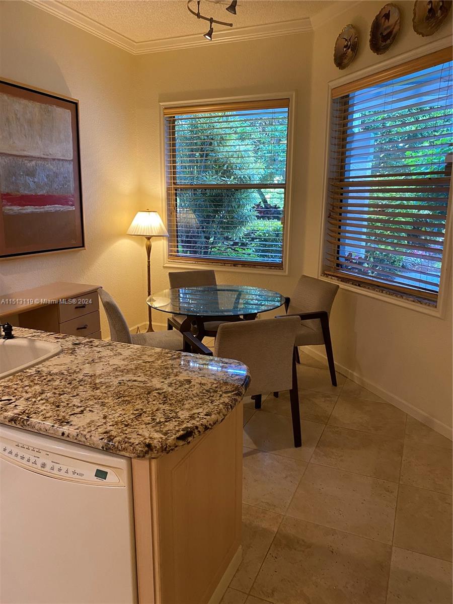 Boca West Boca Raton, FL 33434 - Photo 23 of 28 a view of a kitchen with a sink and wooden cabinets