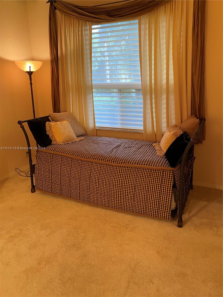 Boca West Boca Raton, FL 33434 - Photo 9 of 28 a bedroom with a bed and a window