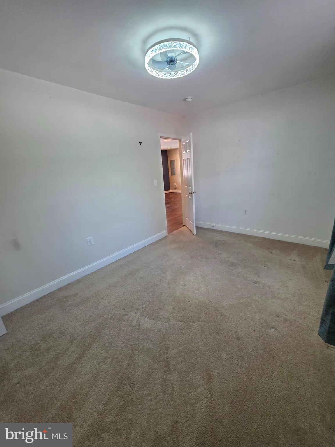 1342 Edna Road Pasadena, MD 21122 - Photo 25 of 31 an empty room with a ceiling fan and window