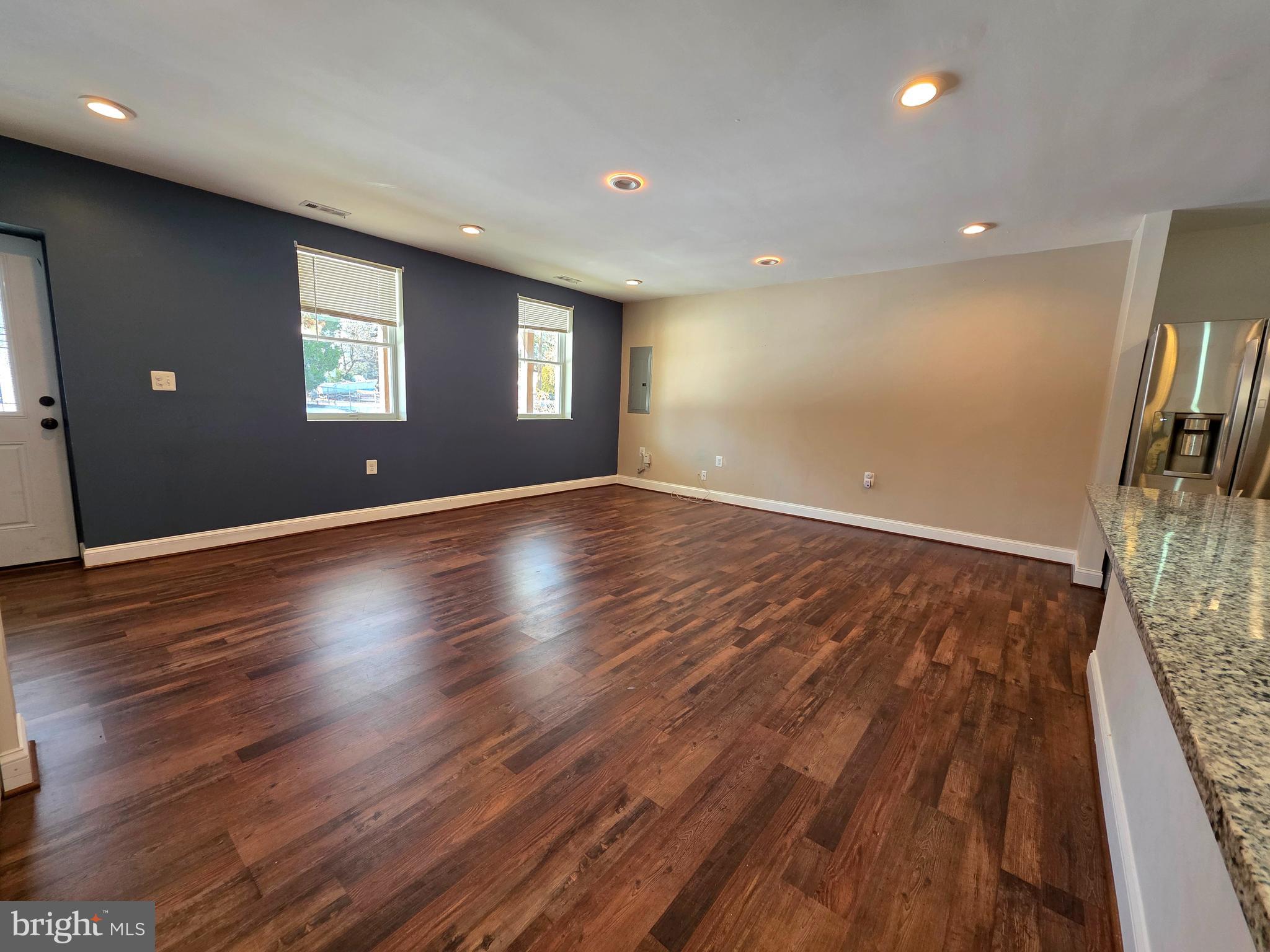 1342 Edna Road Pasadena, MD 21122 - Photo 8 of 31 a view of an empty room with wooden floor and a window
