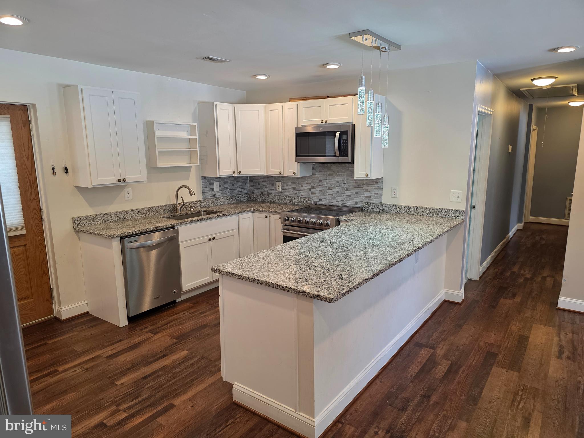 1342 Edna Road Pasadena, MD 21122 - Photo 10 of 31 a kitchen with stainless steel appliances granite countertop wooden floor and sink