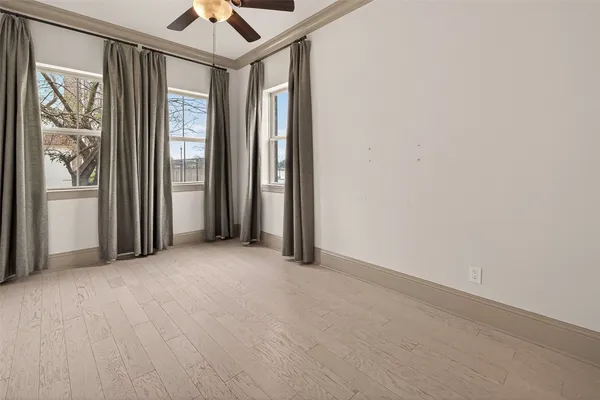 an empty room with windows and closet