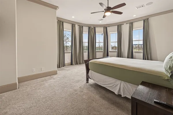 a bedroom with a large bed and a chandelier