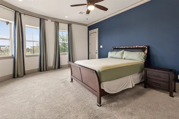 a bedroom with a bed and a large window