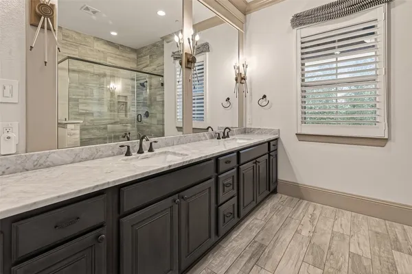 a bathroom with a double vanity sink and a mirror
