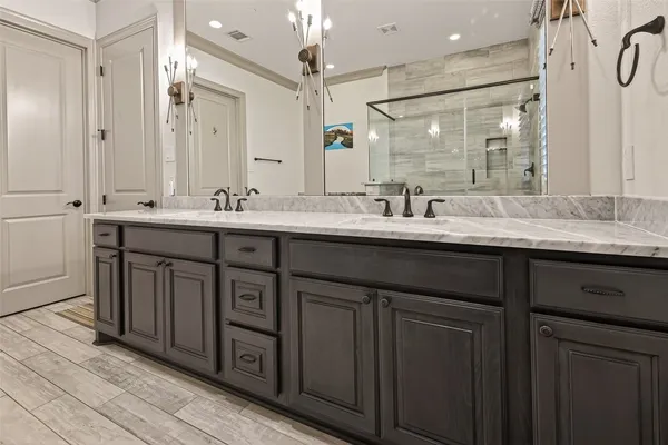 a bathroom with double sink and a mirror