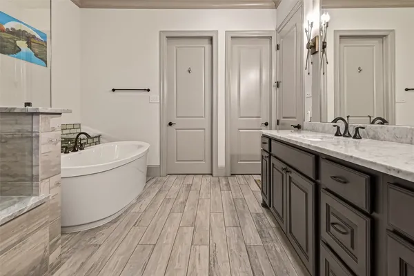a bathroom with a tub sink and a mirror