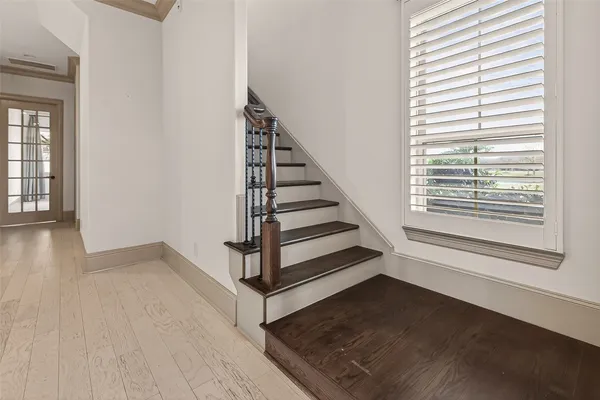 a view of a hallway with wooden floor and entryway