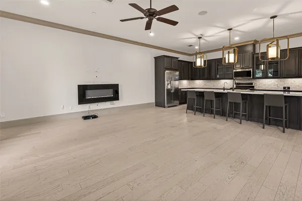 a view of a room with lots of wooden furniture and windows