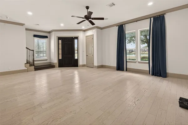 a view of a livingroom with a ceiling fan and window