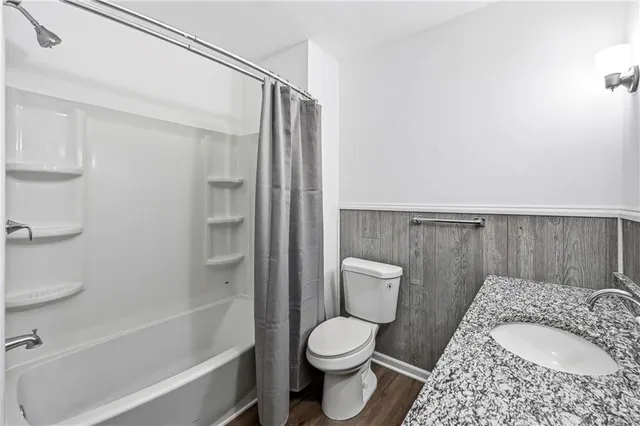 a bathroom with a toilet and a bathtub