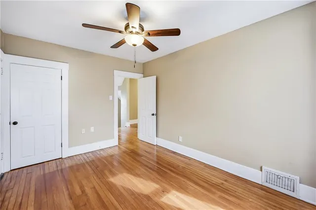 a view of an empty room and wooden floor