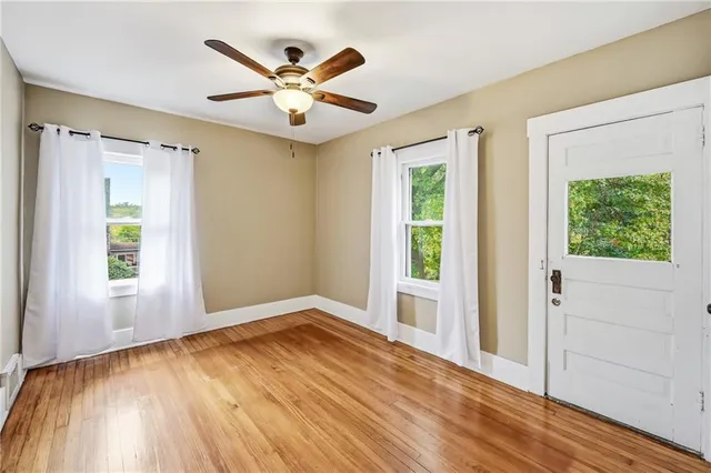 wooden floor in an empty room with a window