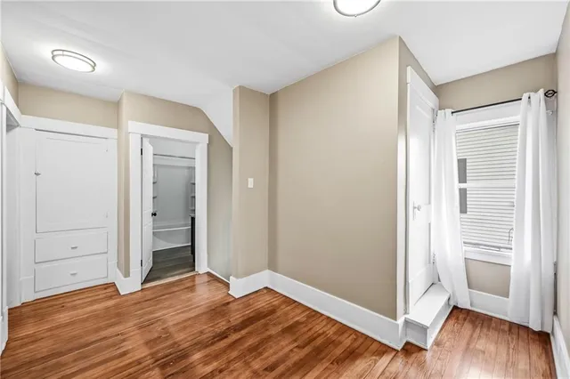 a view of a room with wooden floor and closet